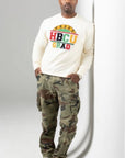 male wearing proud hbcu grad sweatshirt with camo pants on and cream shoes