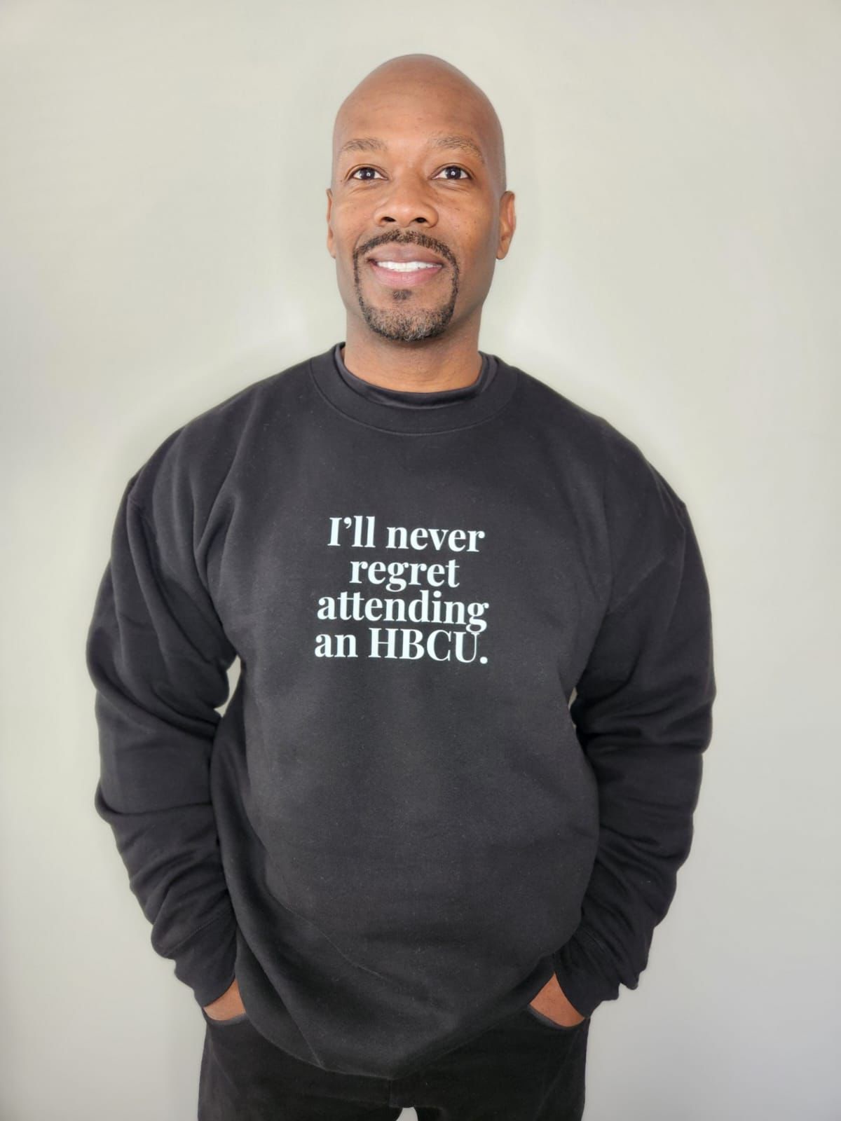 Man wearing black sweater that says I&#39;ll Never Regret Attending AN HBCU